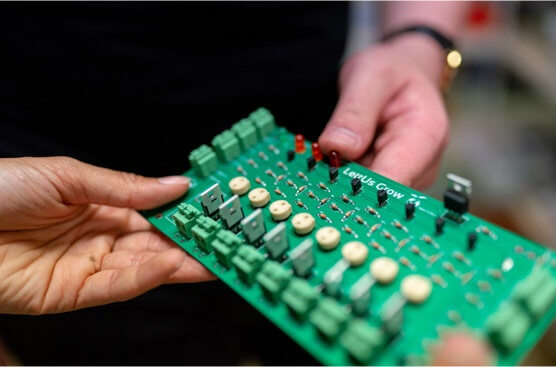 Product engineers holding a circuit board