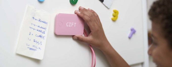 Pink Pigzbe Crypto Storage Wallet held to whiteboard