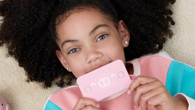 Young girl holding pink Pigzbe Crypto Storage Wallet