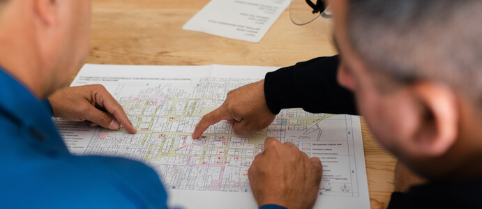 A designer & engineer looking at product blueprints