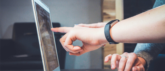 Product designers pointing at a laptop screen